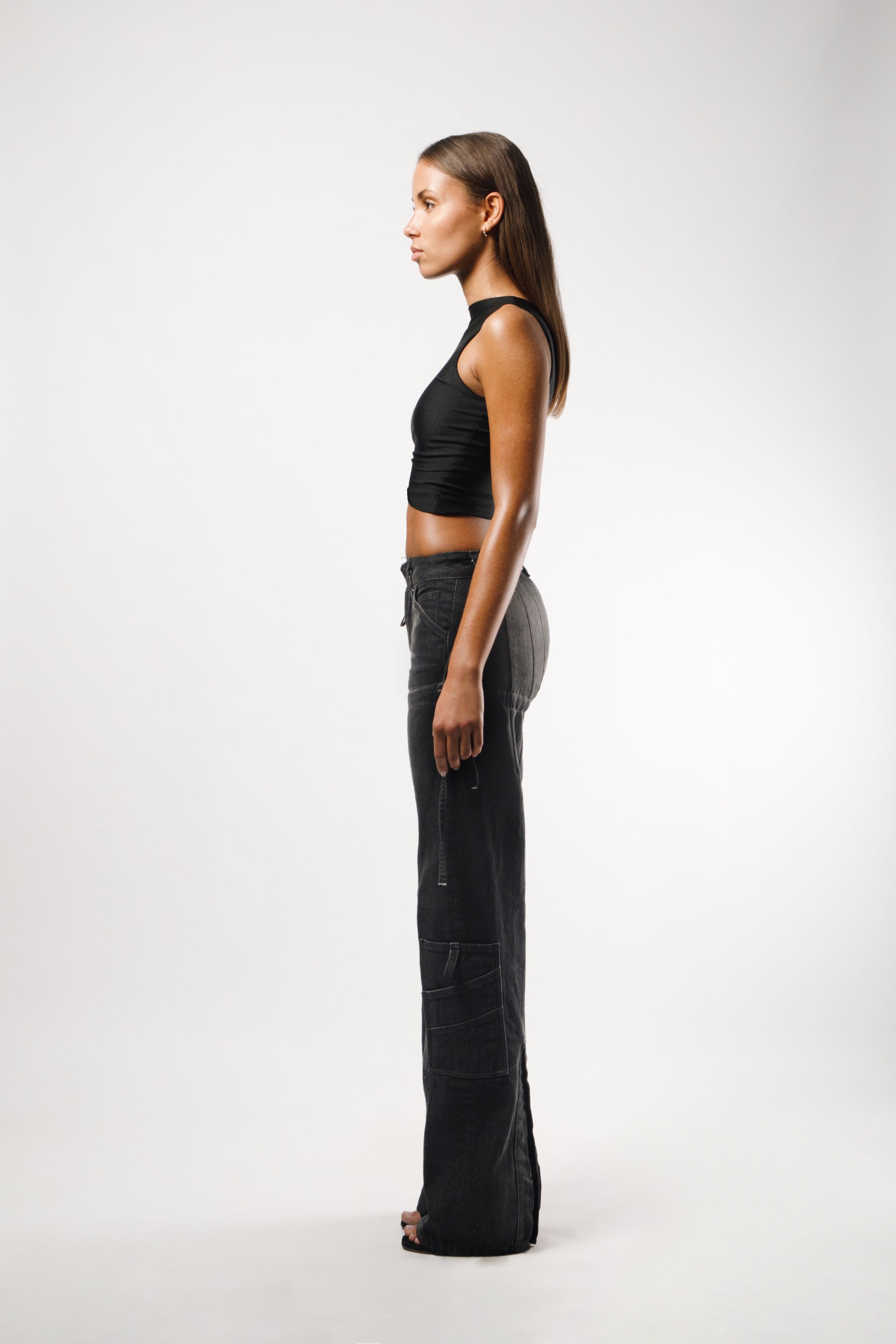 Long pants in washed black cotton with darts and opening slits on the back, adjustable cords to embellish the silhouette - side
