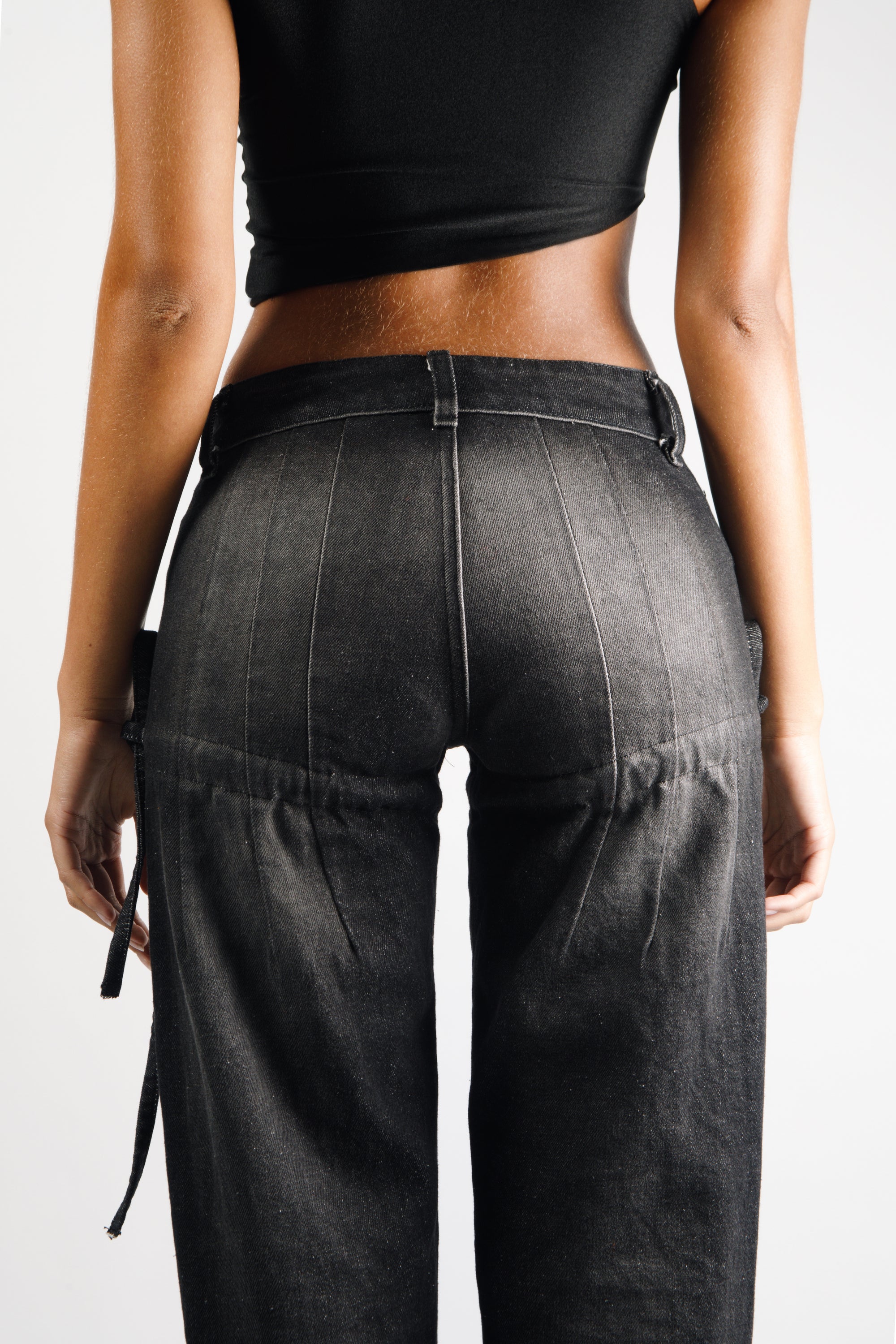 Long pants in washed black cotton with darts and opening slits on the back, adjustable cords to embellish the silhouette - back