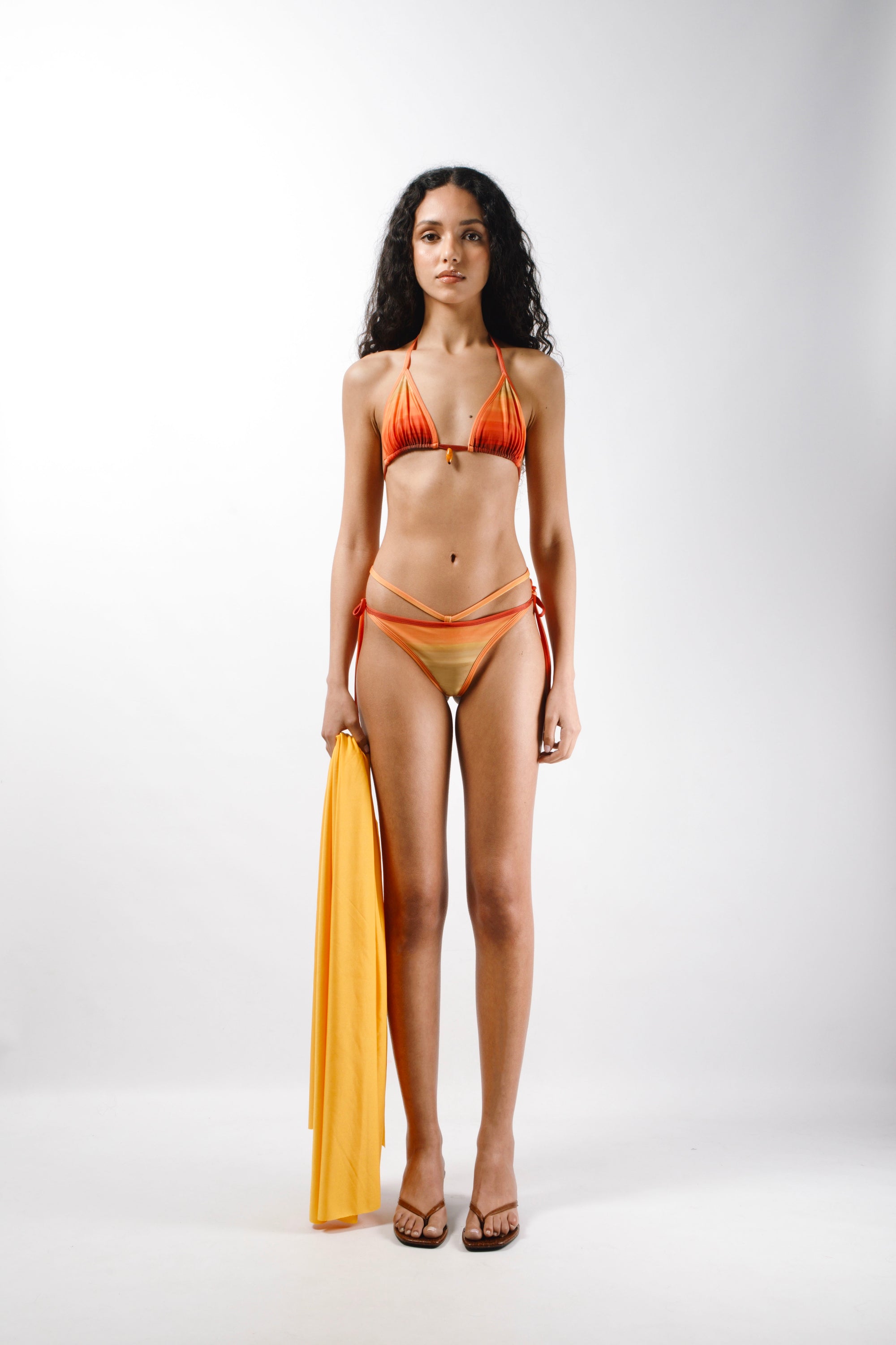 Bikini in Orange, Yellow and Red sunset printed lycra made from recycled plastic bottles with logo metal ends - front
