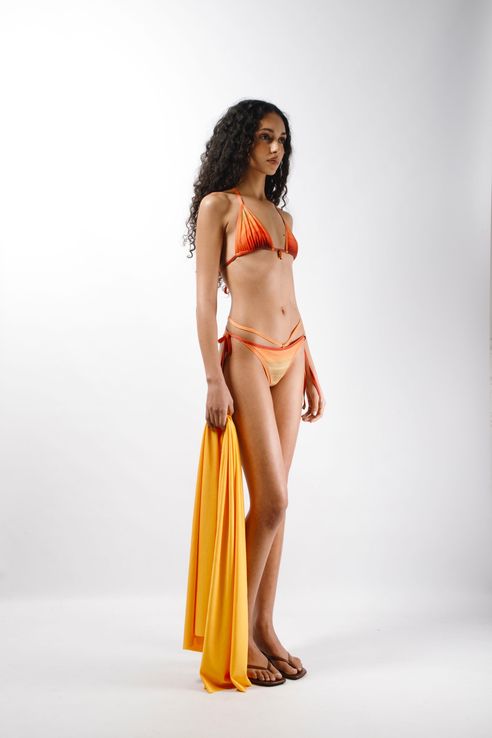Bikini in Orange, Yellow and Red sunset printed lycra made from recycled plastic bottles with logo metal ends - side 