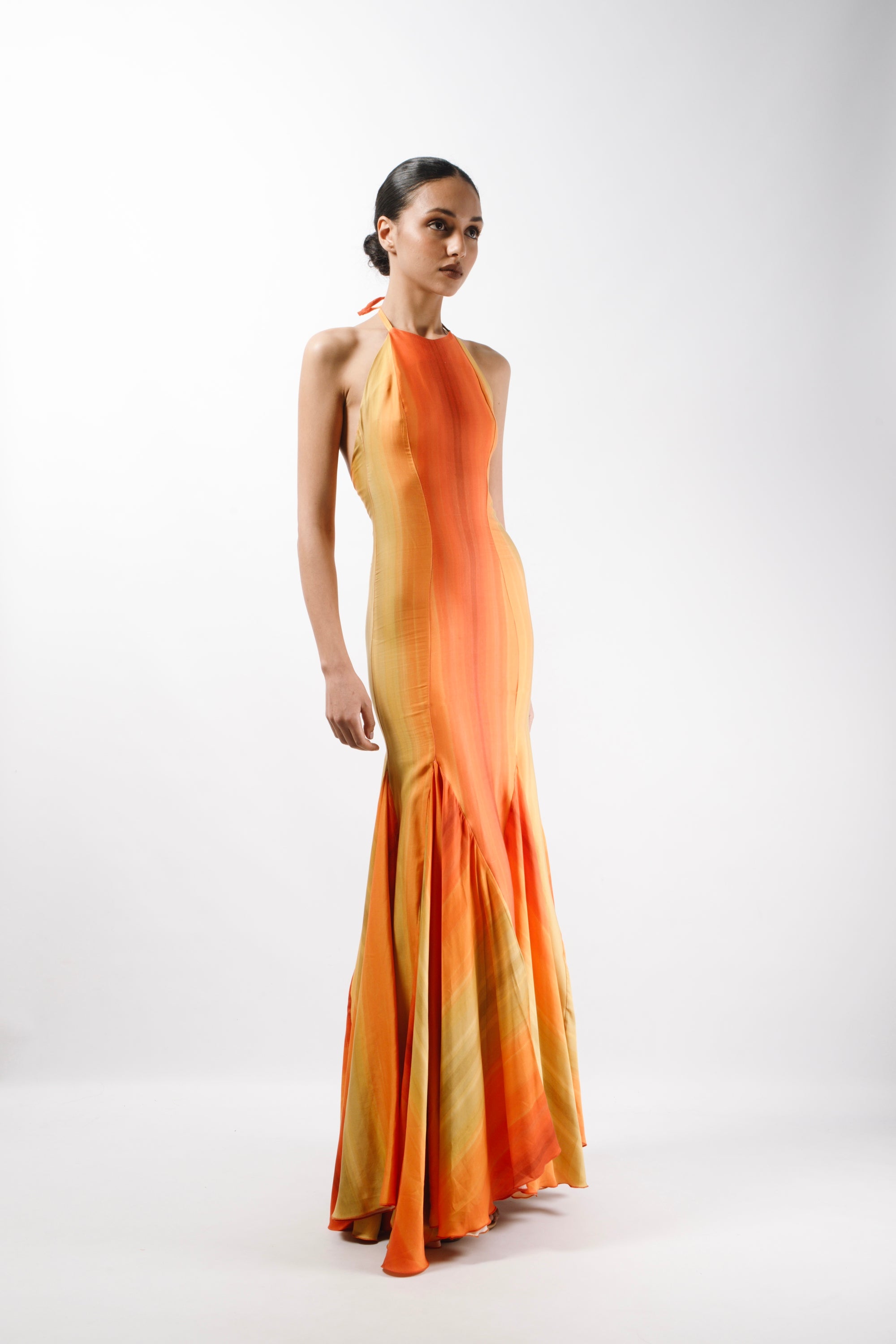 Maxi Gown Dress with long triangle godets and an American neckline with self tie straps. The Dress features an open back - side