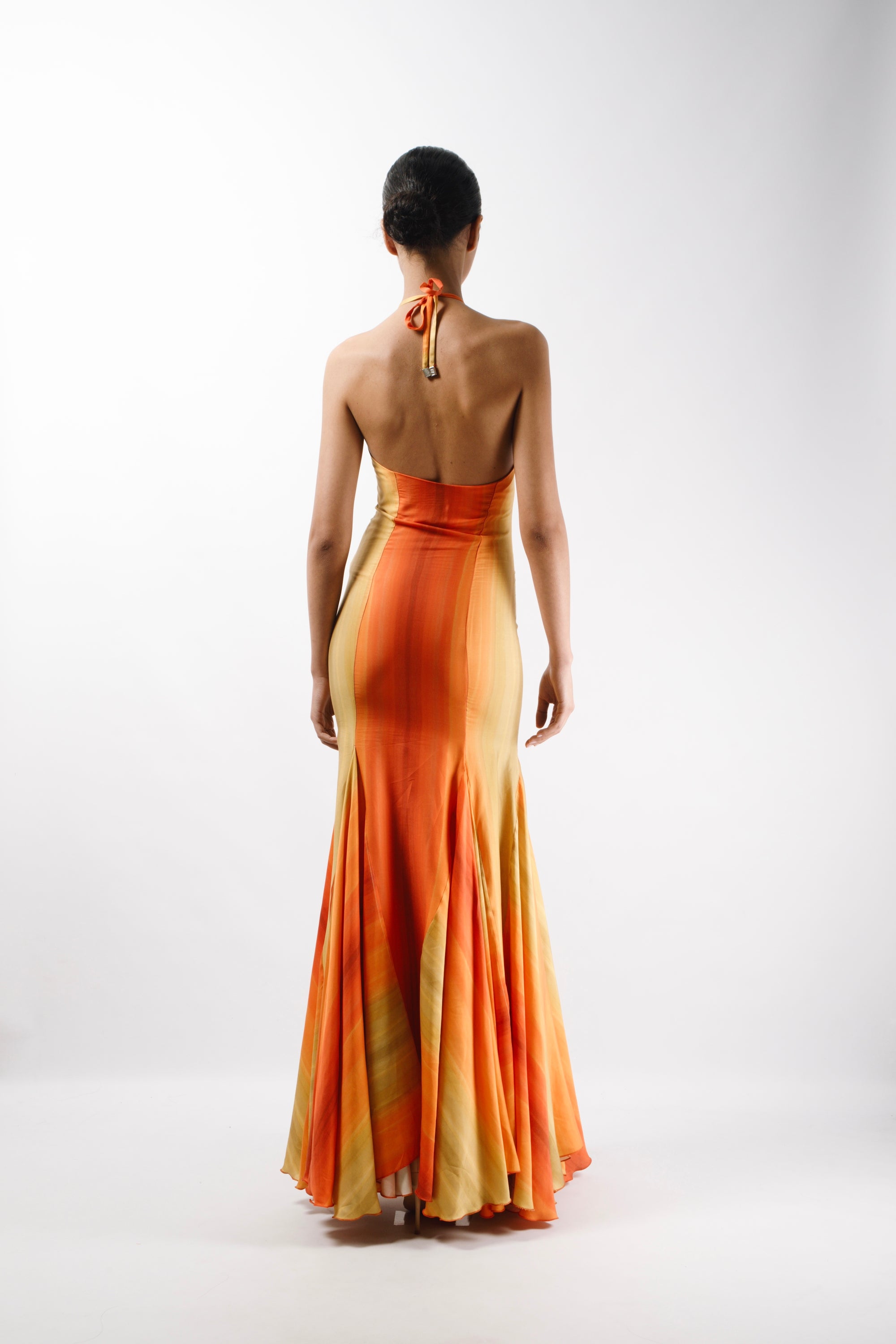 Maxi Gown Dress with long triangle godets and an American neckline with self tie straps. The Dress features an open back - back